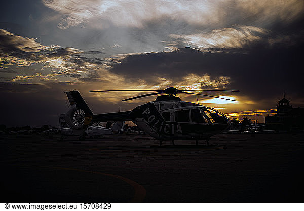 Spain  Madrid  Silhouette of police helicopter in helipad at dawn