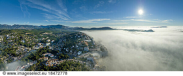 Spain  Majorca  Santa Ponca  Aerial panorama of thick fog floating in front of coastal town
