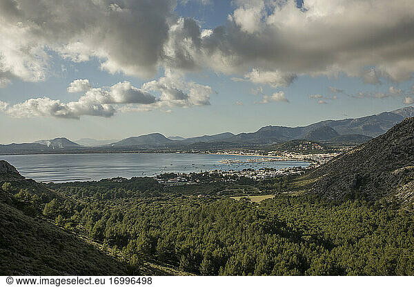 Spain  Mallorca  Port de Pollenca  Forested valley with coastal town and Bay of Pollenca in background