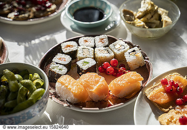 Spain  Plate of ready-to-eat sushi on set dining table