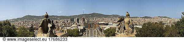 Spain  Province of Barcelona  Barcelona  City panorama with two large statues in foreground