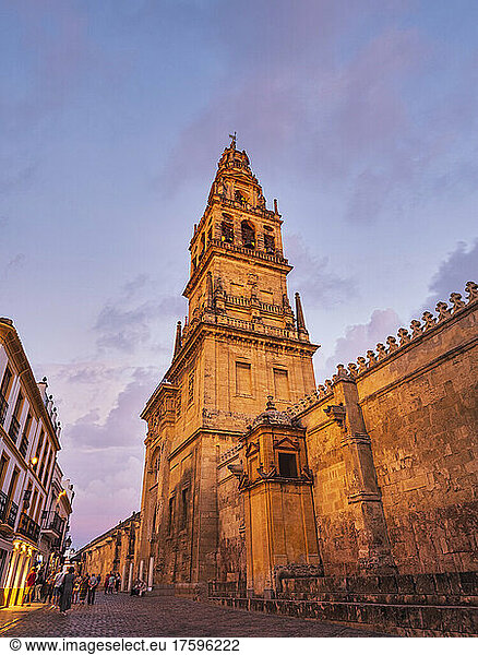 Spain  Province of Cordoba  Cordoba  Fortified walls and tall bell tower in historic old town at dusk