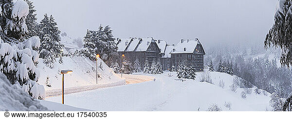 Spain  Province of Lleida  Baqueira-Beret  Street lights illuminating snow-covered road leading to ski resort in Pyrenees