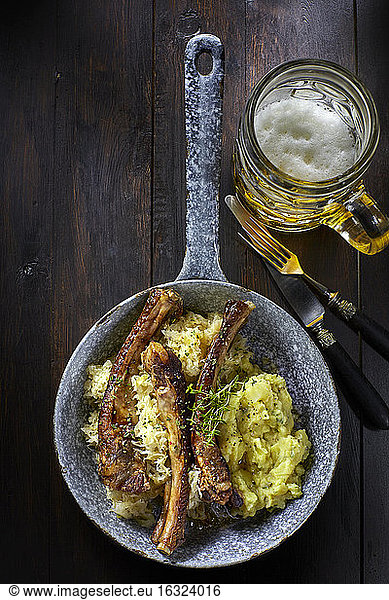 Spare ribs with sauerkraut and mashed potatoes in pan