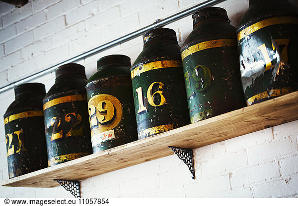 Specialist coffee shop. A row of coffee tins on a shelf.