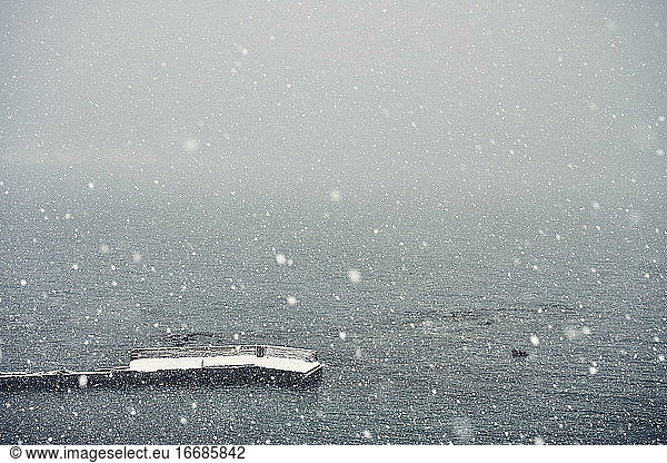 Spectacular seascape with pier during snowfall