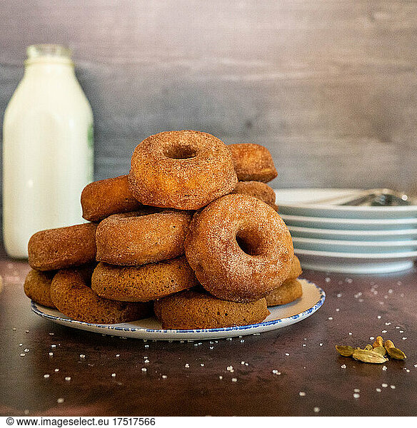 Spiced donuts with milk and plates