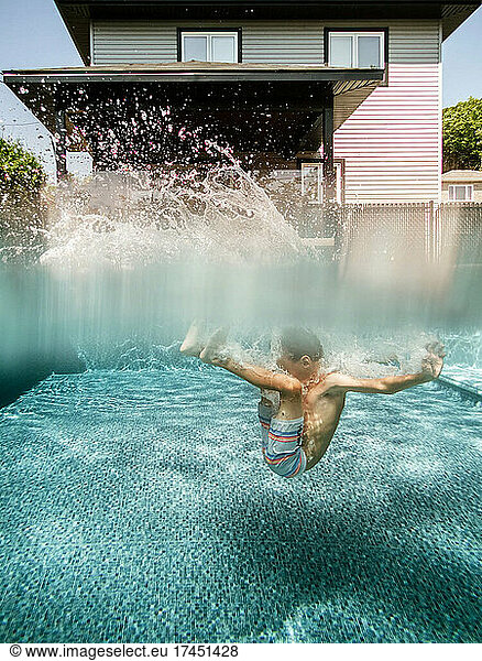 Split view of a 7 years old boy jumping in a pool at home