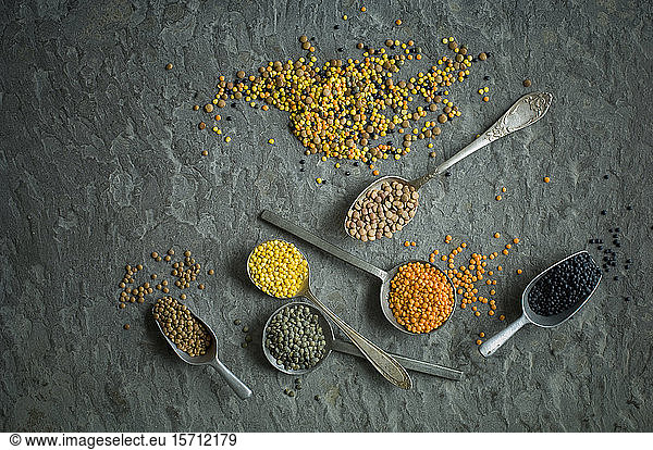 Spoons of colorful lentils