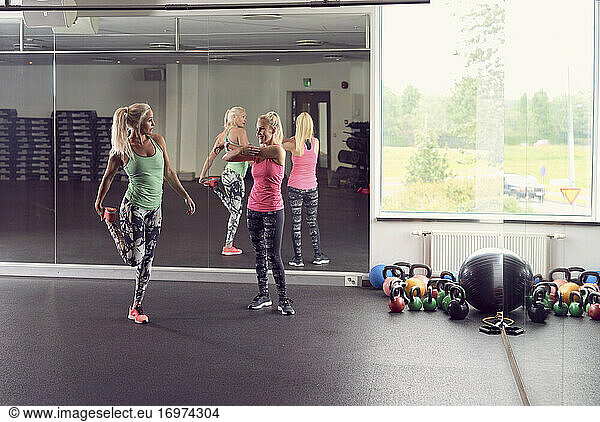 Sportive women warming up in fitness club