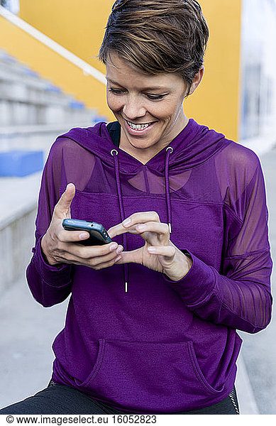 Sportliche Frau mit Smartphone