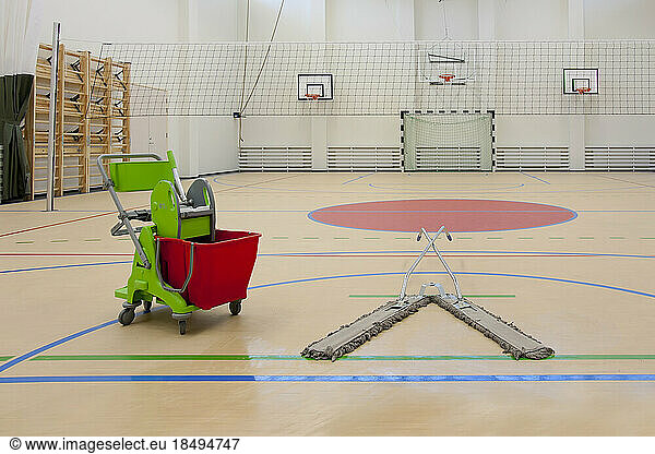 Sports and exercise facilities indoors. Gym. Basketball indoor court  a sports hall  a mop and bucket.