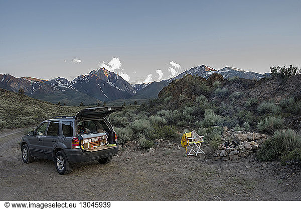 Sports utility vehicle parked at campsite against Mount Morrison