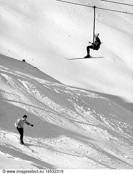 sports  winter sports  ski  lift  man with skis sitting in gondola  man is skiing  1960s