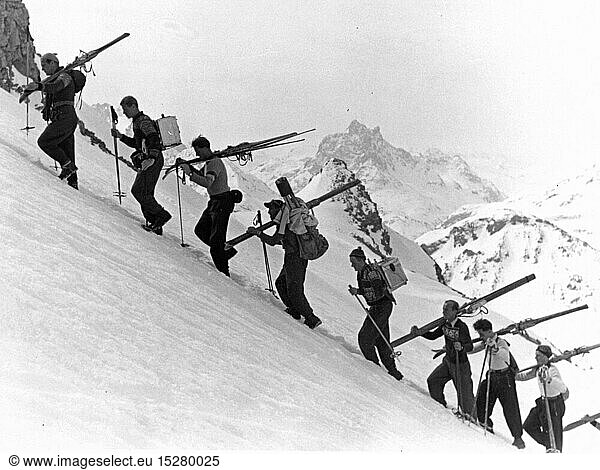 sports  winter sports  skiing  ski tour  group of men climbing a mountain  1930s