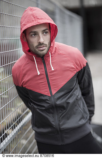 Sporty man in hooded jacket
