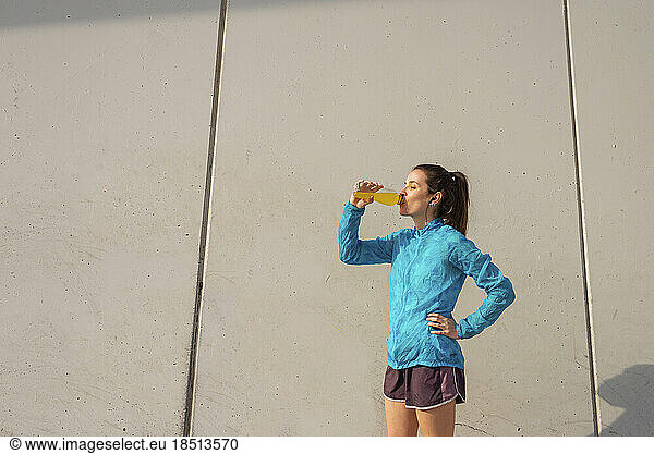 Sporty Young Woman Drinking Water After Exercise