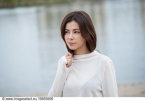 spring beautiful brunette girl on a background of water