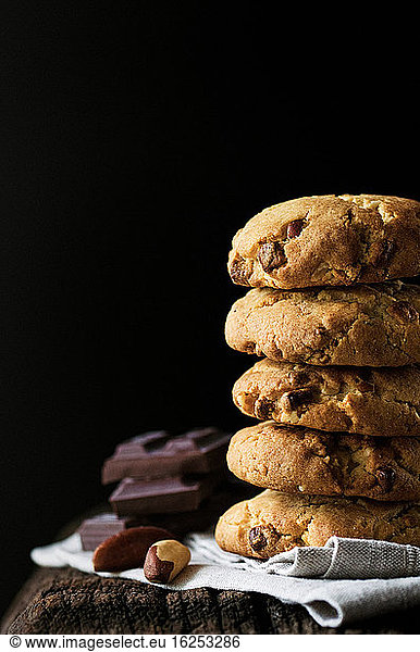 Stack of chocolate chip cookies with Brazil nuts