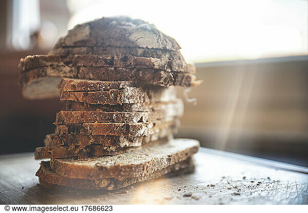 Stack of fresh baked bread slices on table