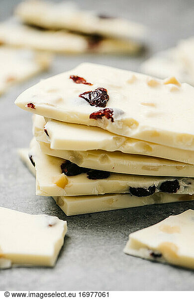 Stack of white chocolate bark pieces with cranberry and macadamia nuts
