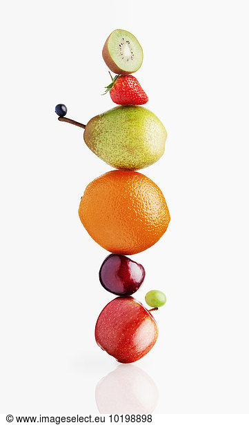 Stacked fruit on white background