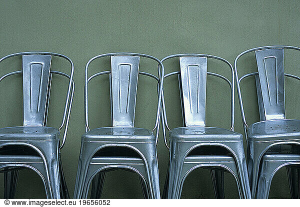 Stacked silver metal chairs.