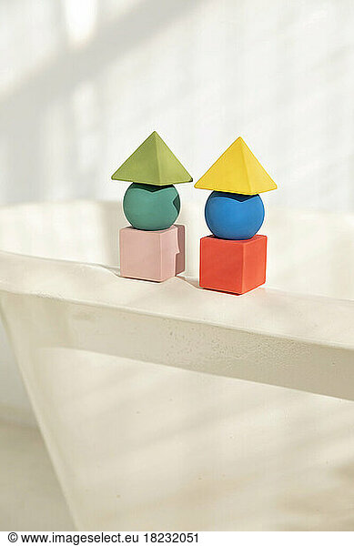 Stacks of toy blocks standing on bathtub rim