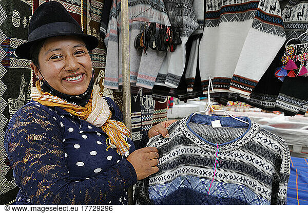 Stall holder selling knitwear at Otavalo market  Otavalo  Ecuador  South America