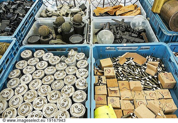 Stand at militaria fair selling World War Two memorabilia like bomb fuzes  M67 fragmentation grenades  bullets  ammunition and WW2 anti-tank No. 74 sticky bombs