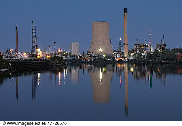 Stanlow Oil Refinery reflected in the Manchester Ship Canal at night  near Ellesmere Port  Cheshire  England  United Kingdom  Europe