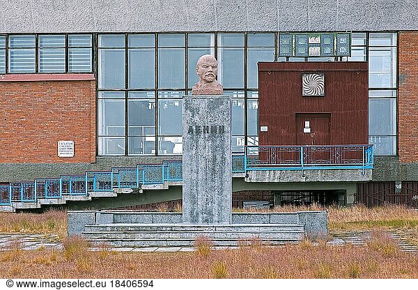 Statue of Lenin and sport and cultural centre at Pyramiden  abandoned Soviet coal mining settlement on Svalbard  Spitsbergen