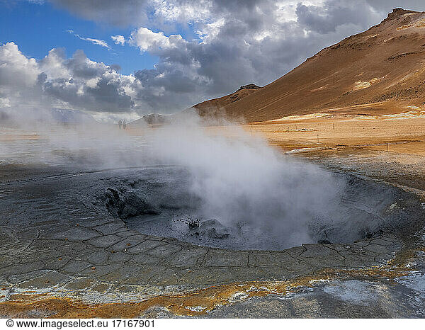 Steam emitting from geyser against mountain  Hverir  Iceland