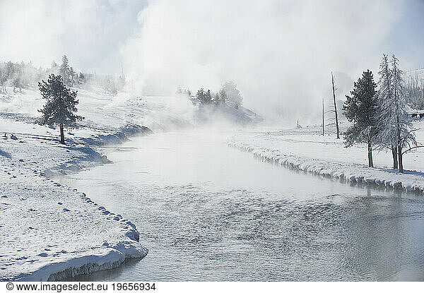 Steam rising from a river in winter in Yellowstone National Park  Wyoming.