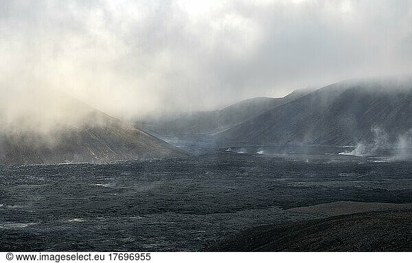 Steaming lava fields between hills  volcanic eruption  active table volcano Fagradalsfjall  Krýsuvík volcanic system  Reykjanes Peninsula  Iceland  Europe