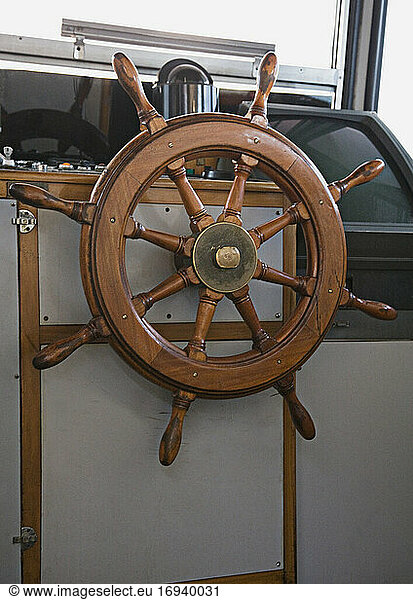 Steering wheel in boat's cabin.