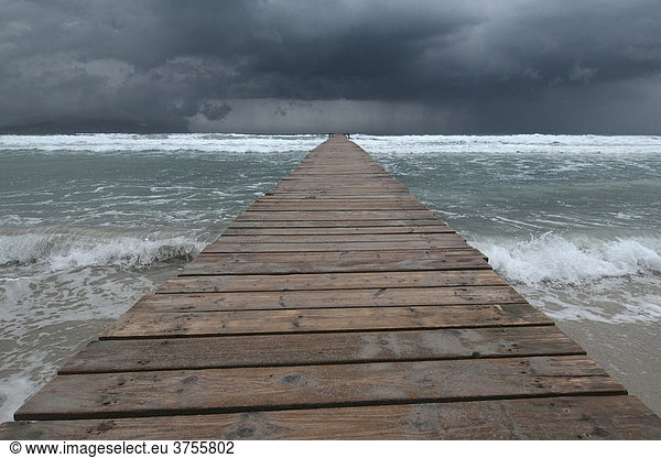 Steg in das Mittelmeer  dunkle  bedrohliche Wolken  Muro  Mallorca  Spanien  Europa