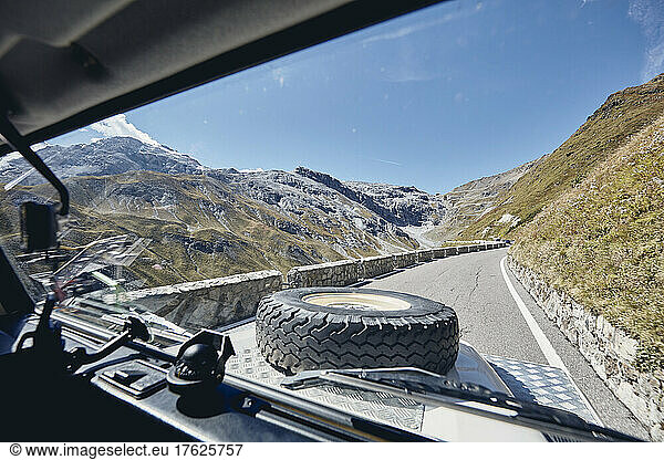 Stelvio Pass seen through windshield of off-road vehicle  South Tyrol  Italy
