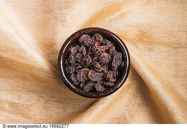 Still life of raisins on a decorative cloth