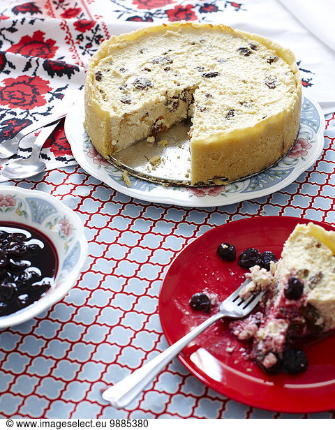 Still life of Ukrainian cheesecake with a bowl of blueberries