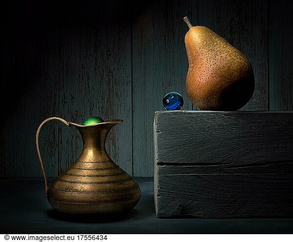 Still life with brass vase  pear and glass ball  studio shot  dark background