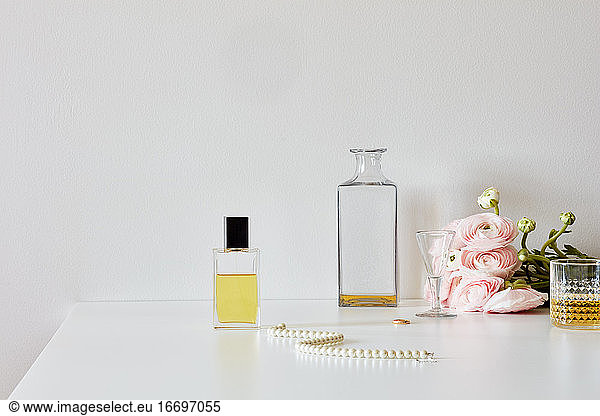 Still life with perfume  whisky  roses  necklace