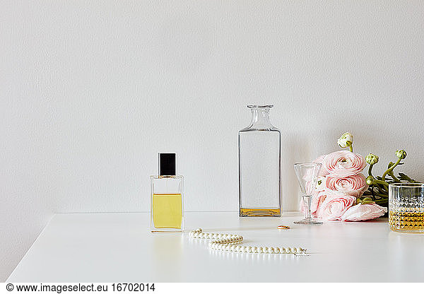 Still life with perfumes  whiskey  necklace  roses