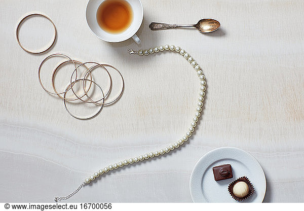 Stilleben mit Teetasse  Schmuck  Halskette  Pralinen