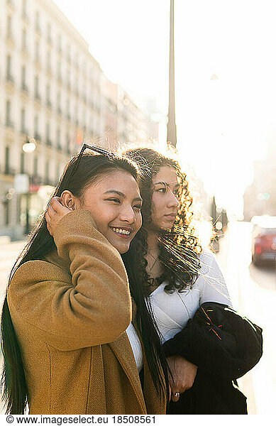 Stock photo of a profile shot of two friends standing