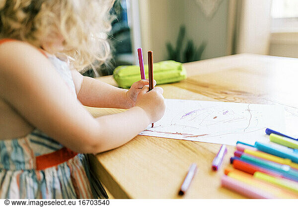 Stock portrait of a little toddler girl drawing