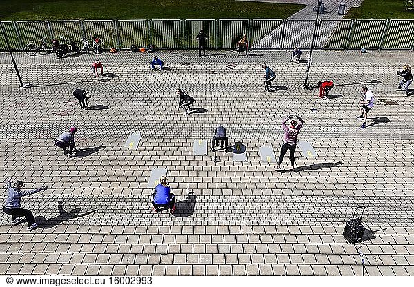 Stockholm  Sweden People at an outdoor aerobics session led by instructor with music at the Eriksdalsbadet pool.