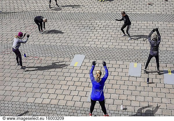 Stockholm  Sweden People at an outdoor aerobics session led by instructor with music at the Eriksdalsbadet pool.