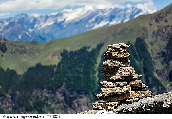 Stone cairn in Himalayas with mountains in background. Near Manali  above Kullu Valley  Himachal Pradesh  India  Asia