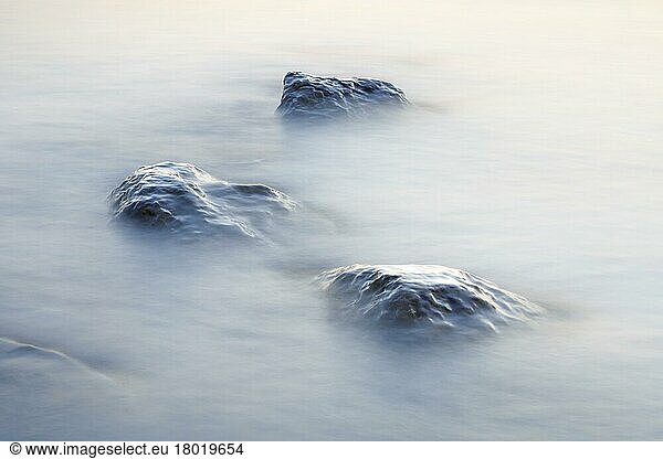 Stones in water photographed with slow shutter speed  Lake Constance near Arbon  Switzerland  Europe